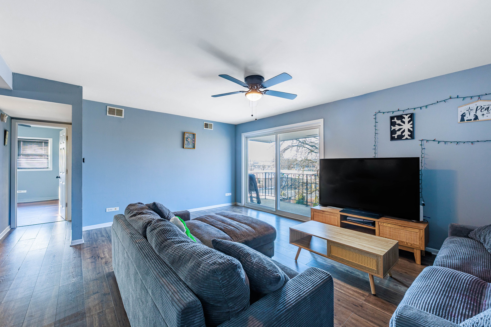 11036 Kilpatrick Avenue, Unit 3SW Oak Lawn, IL 60453 - Photo 3 of 19 a living room with furniture and a flat screen tv