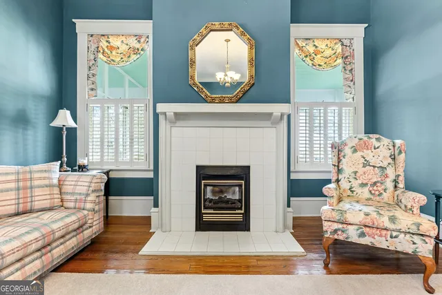 a living room with a fireplace and a potted plant