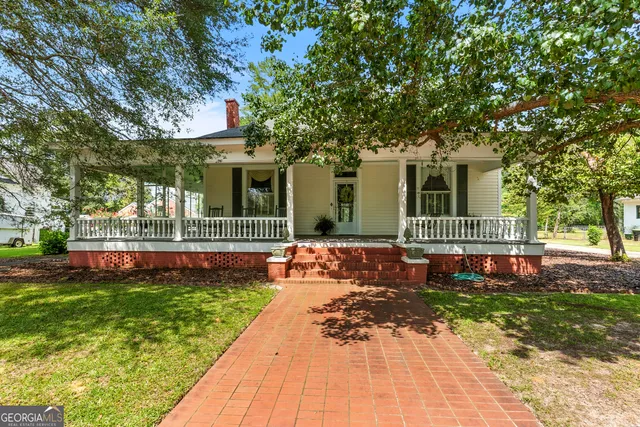 a dining room with furniture and floor to ceiling window