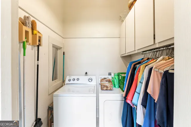 a dining room with wooden floor and white walls