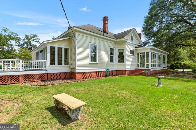 a front view of a house with a garden and yard