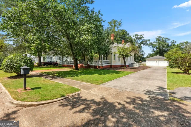 a living room with furniture a fireplace and a chandelier