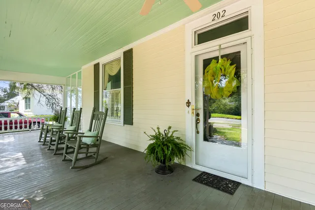 a living room with furniture a chandelier and a flat screen tv