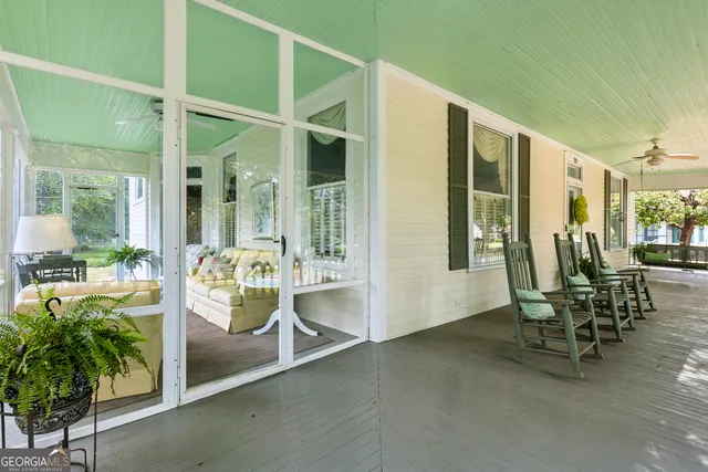 a view of a dining room and livingroom with furniture wooden floor a chandelier