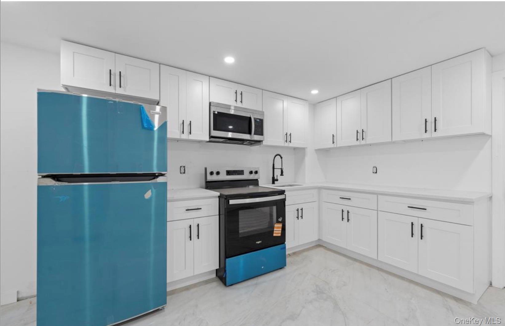 752 Lenox Road Brooklyn, NY 11203 - Photo 12 of 14 Kitchen featuring stainless steel appliances, white cabinets, and recessed lighting