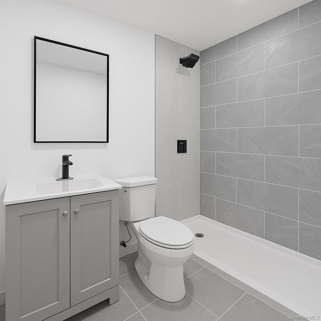 752 Lenox Road Brooklyn, NY 11203 - Photo 14 of 14 Bathroom featuring vanity, tile patterned flooring, and a shower stall
