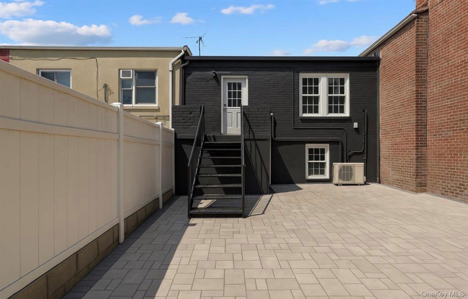 752 Lenox Road Brooklyn, NY 11203 - Photo 5 of 14 Back of house with a patio and stucco siding