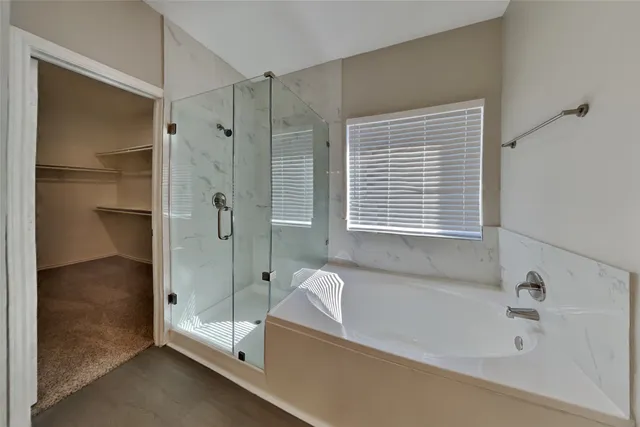 a bathroom with a bathtub and a shower