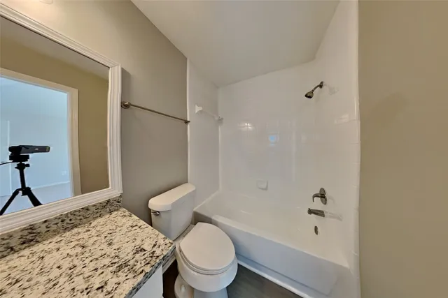 a bathroom with a toilet sink and shower