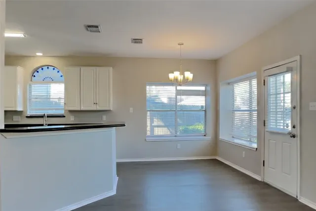 a view of a kitchen with a sink and window