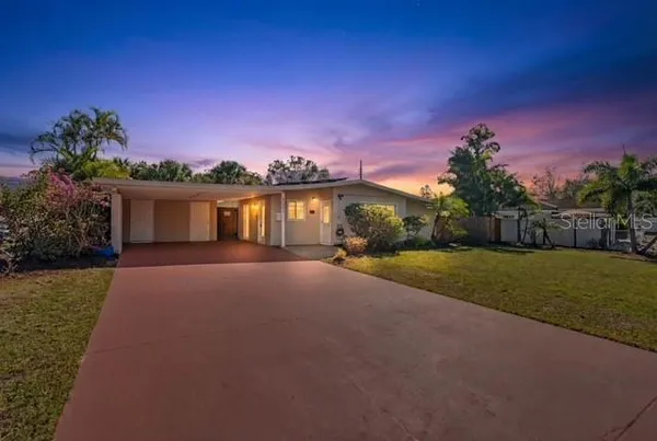 a front view of a house with a yard and a garage