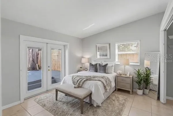 a bedroom with a bed and a potted plant