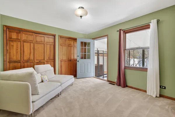 a living room with furniture and large windows