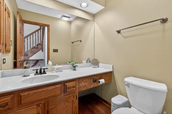 a bathroom with a sink mirror vanity and toilet