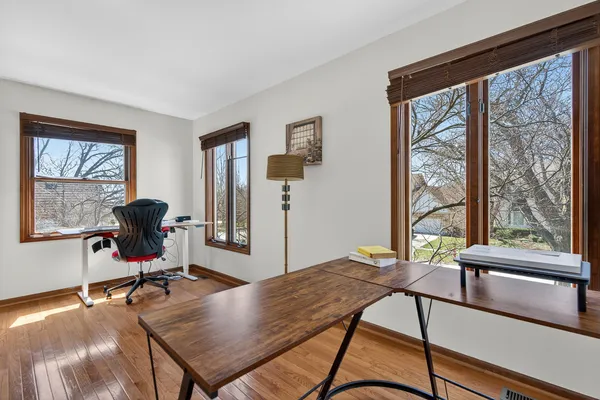 a view of a workspace with furniture and a window