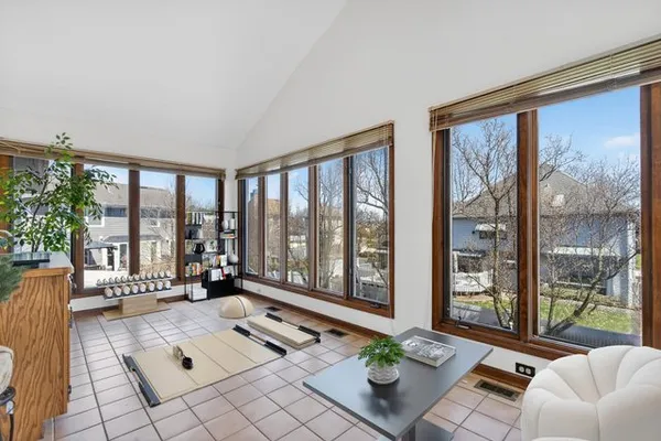 a living room with furniture and floor to ceiling windows