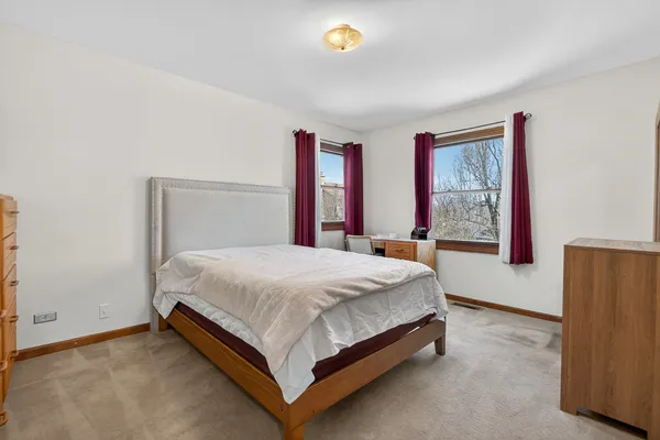 a bed sitting in a bedroom next to a window