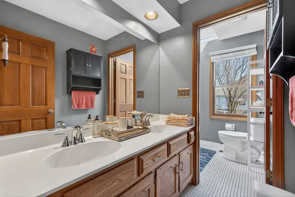 a bathroom with a sink double vanity and a toilet
