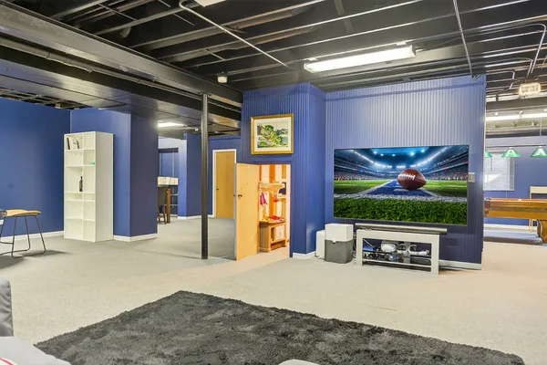 a view of a hallway with two couches and chandelier