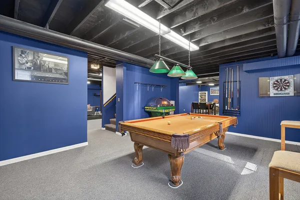 a room with furniture and pool table