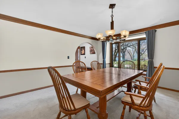 a view of a dining room with furniture and window