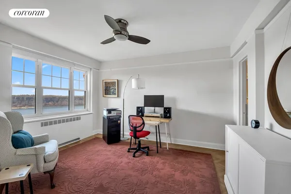 a bedroom with a bed and a potted plant