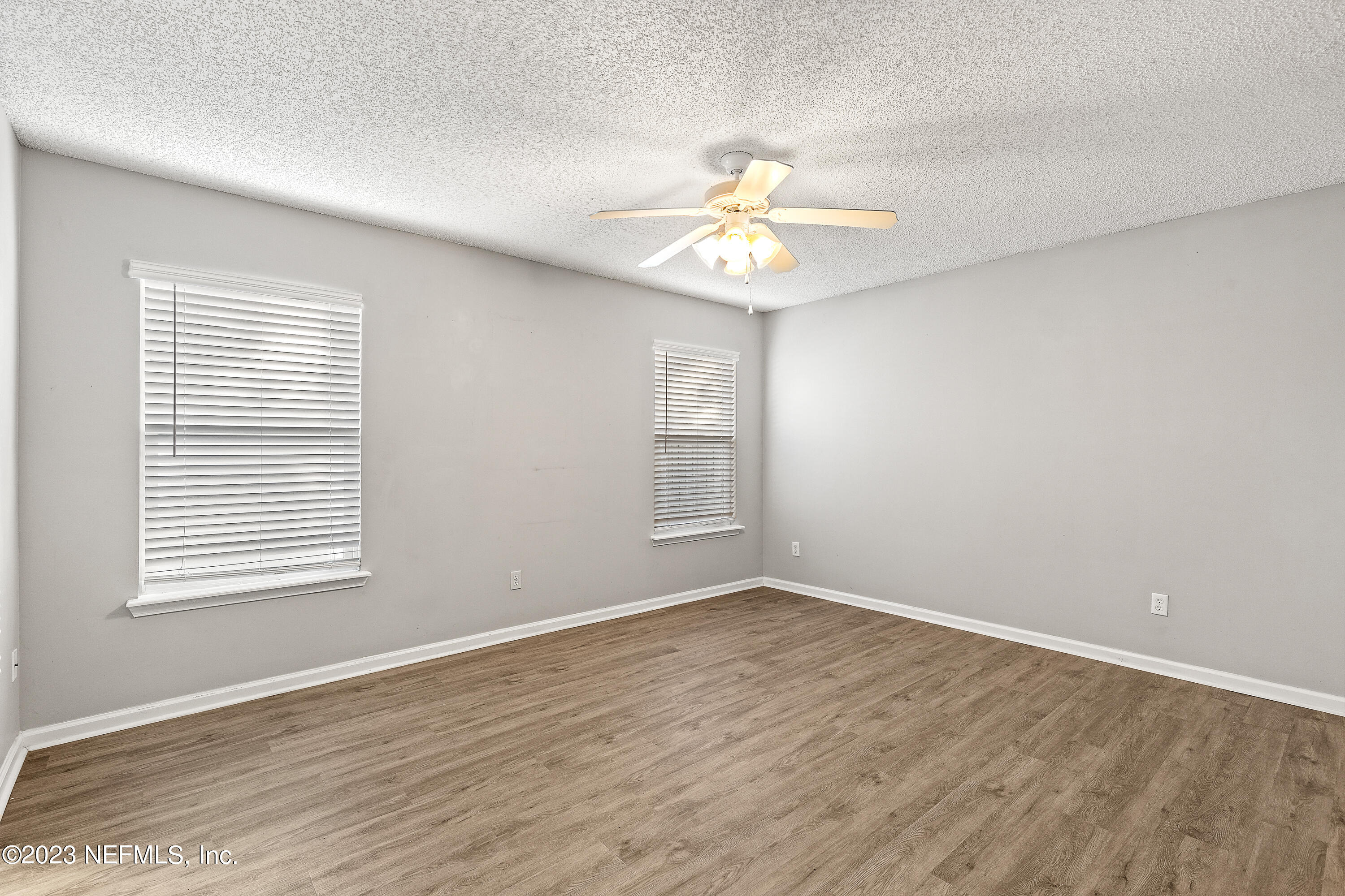 13240 Pacemaker Drive Jacksonville, FL 32225 - Photo 11 of 21 a view of an empty room with a window and wooden floor