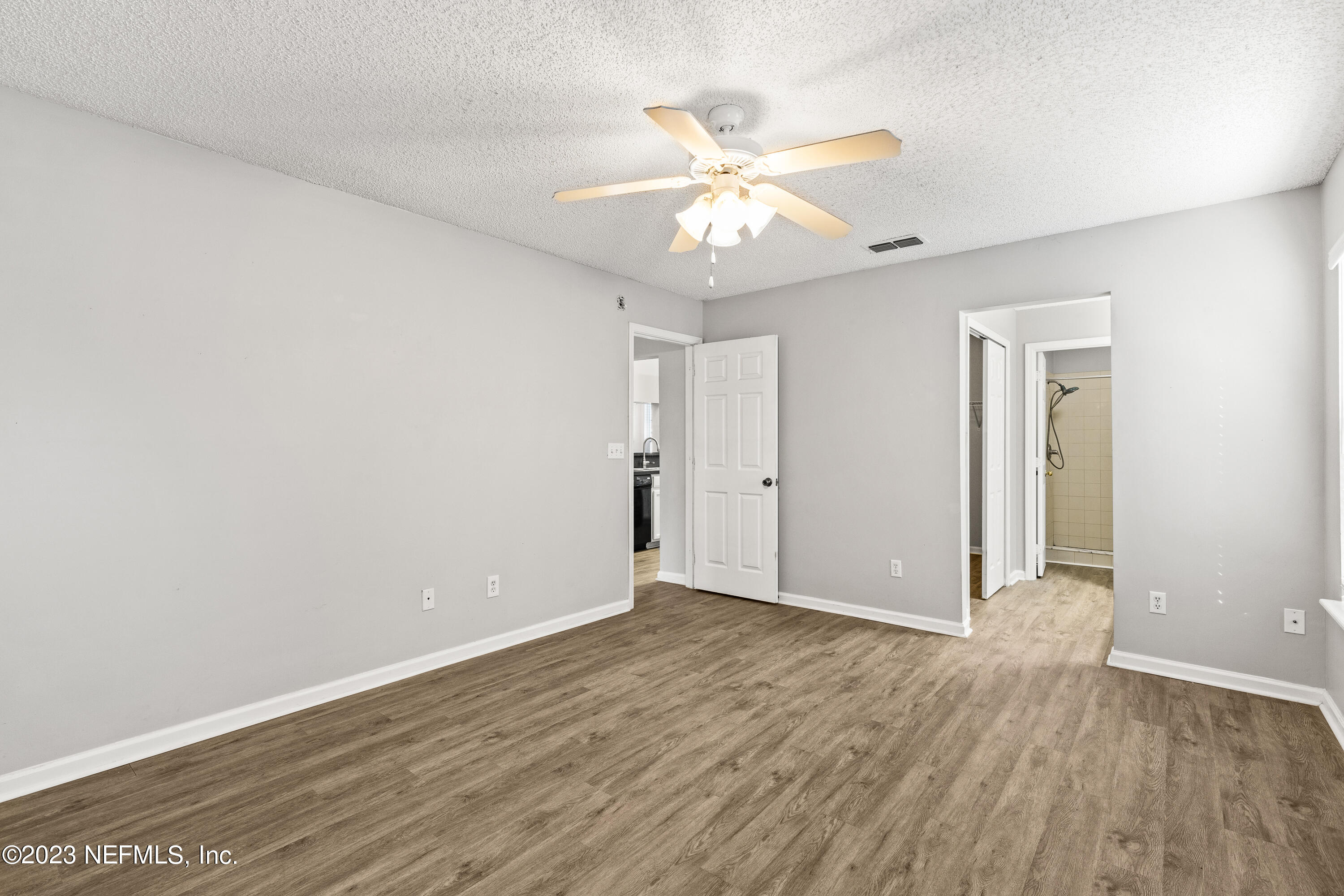 13240 Pacemaker Drive Jacksonville, FL 32225 - Photo 12 of 21 an empty room with wooden floor and fan