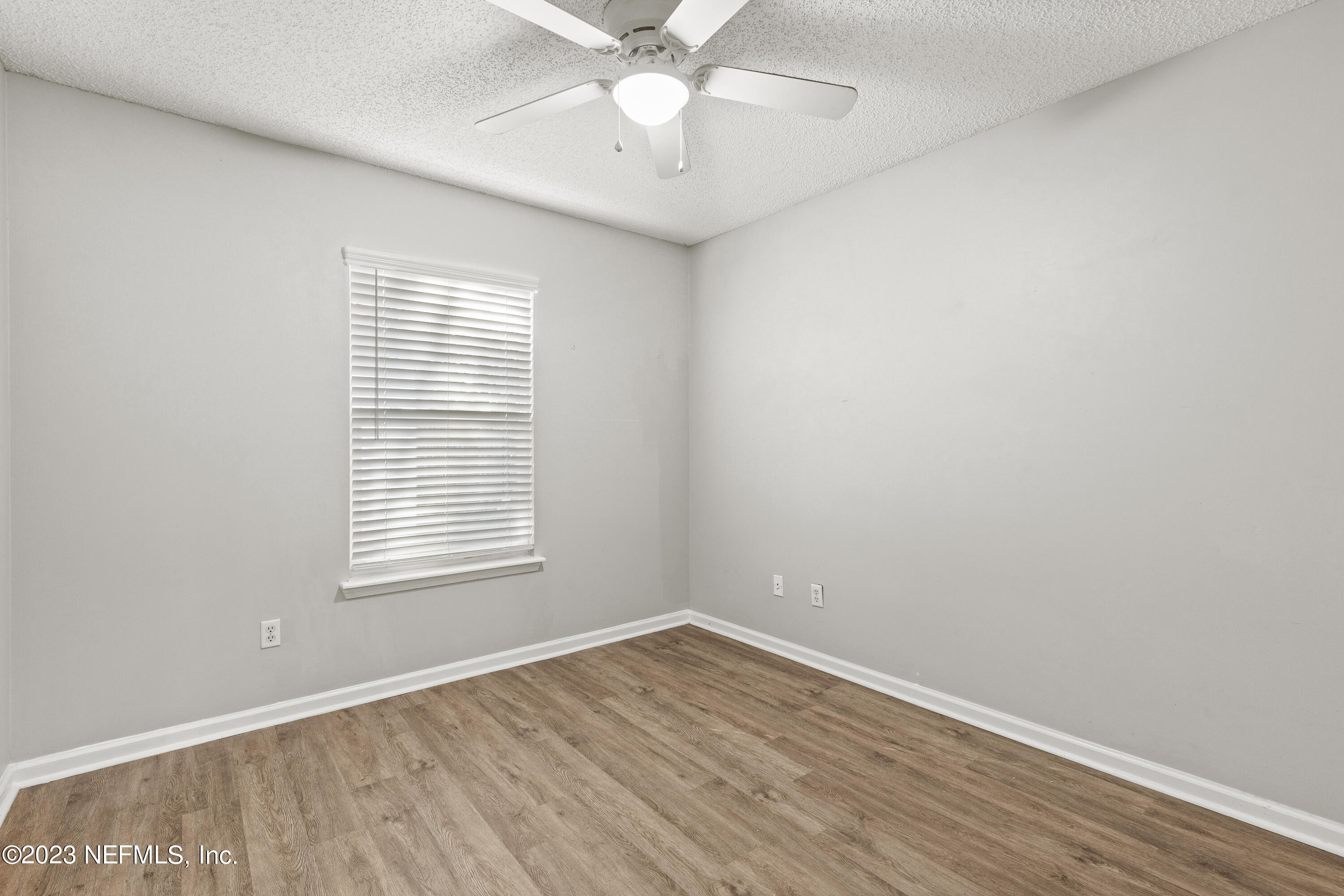 13240 Pacemaker Drive Jacksonville, FL 32225 - Photo 17 of 21 wooden floor in an empty room with a window