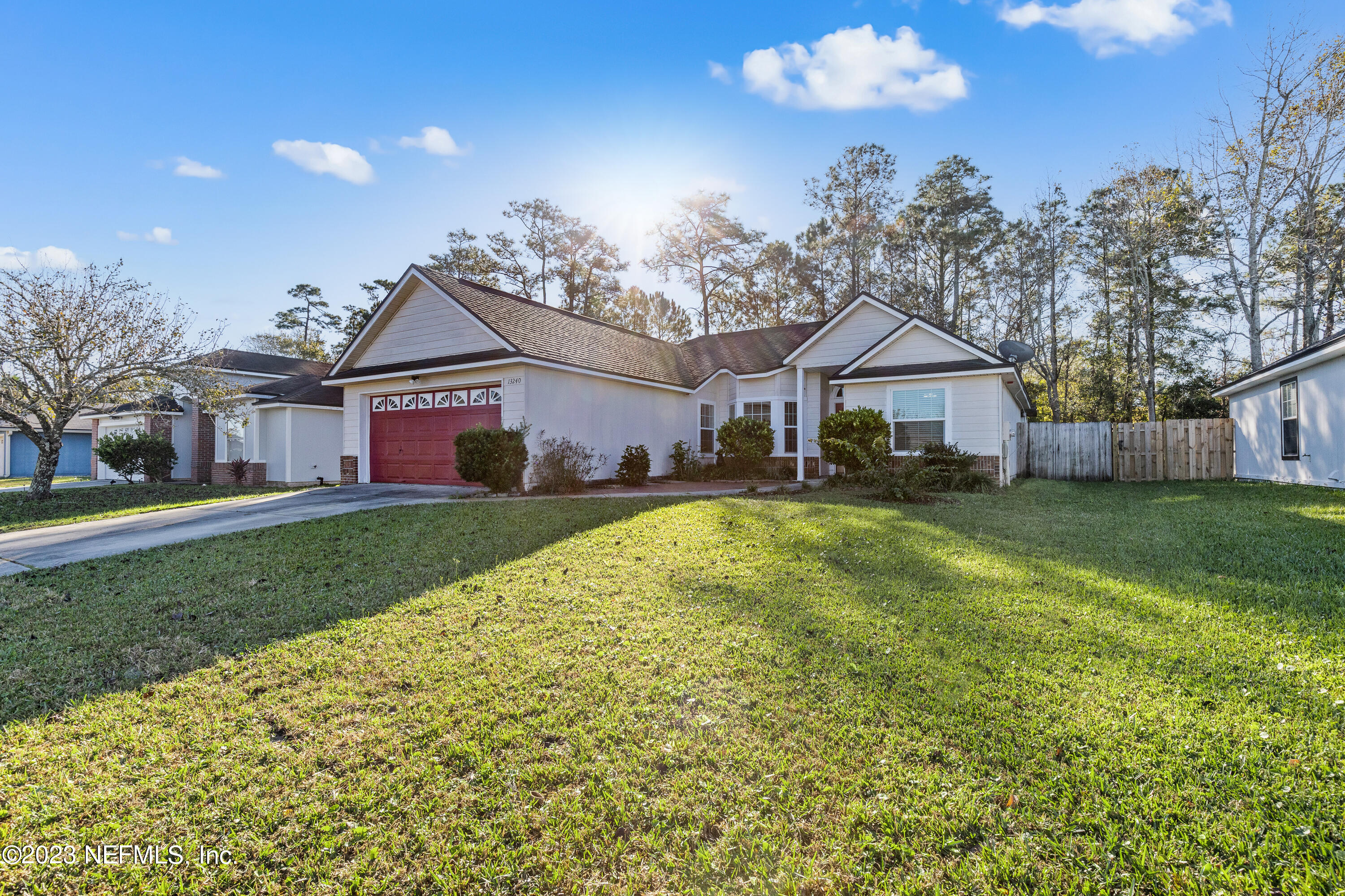 13240 Pacemaker Drive Jacksonville, FL 32225 - Photo 2 of 21 a front view of a house with a garden and plants