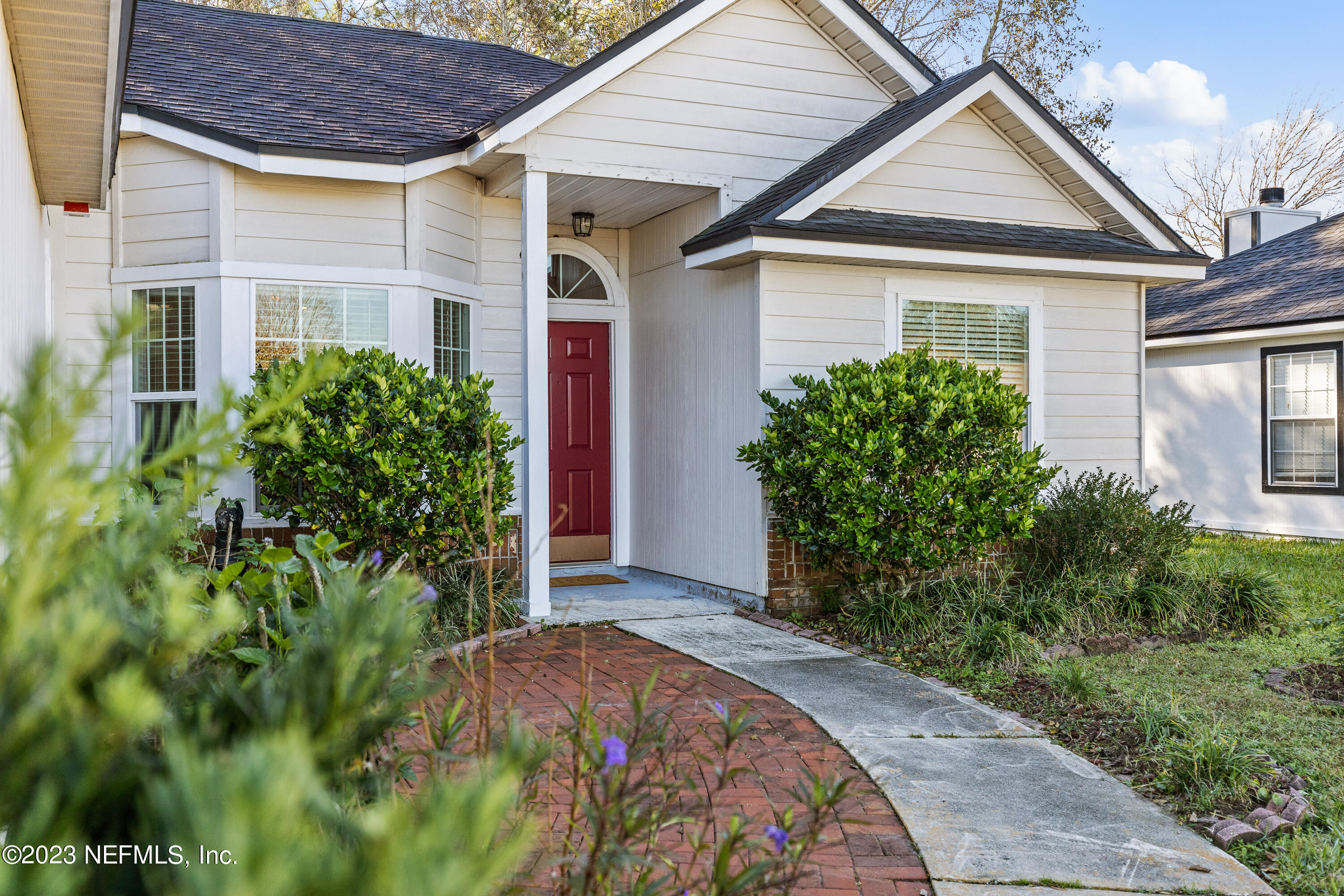 13240 Pacemaker Drive Jacksonville, FL 32225 - Photo 3 of 21 front view of house with a yard and potted plants