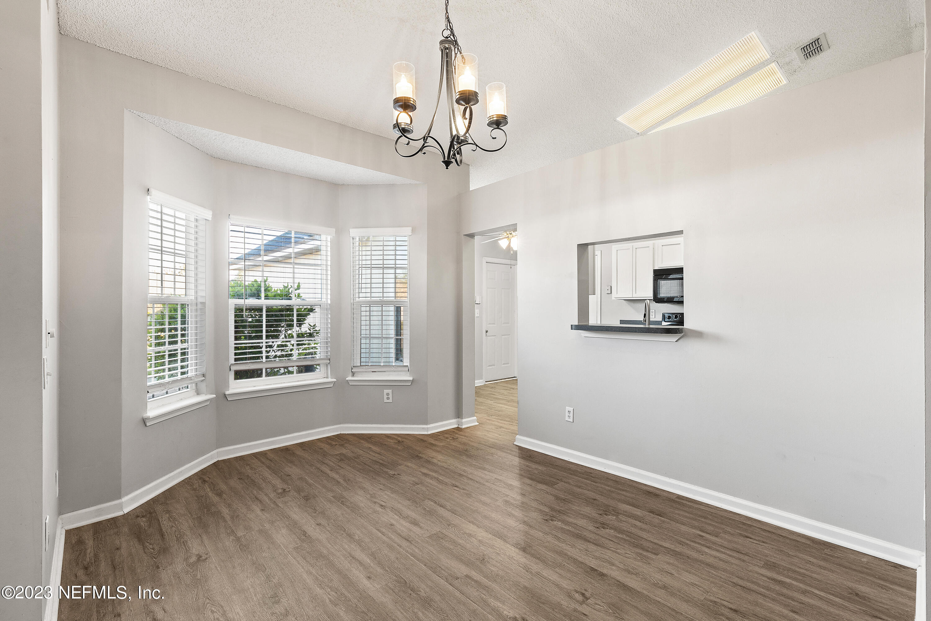 13240 Pacemaker Drive Jacksonville, FL 32225 - Photo 5 of 21 a view of an empty room with wooden floor and a window