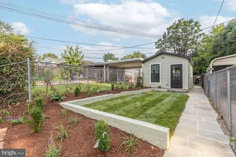 a living room with white cabinets and potted plant
