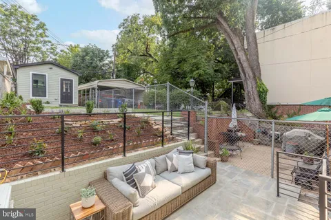 a view of house with a yard and potted plants