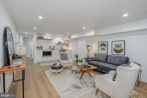 a bedroom with furniture and a large window