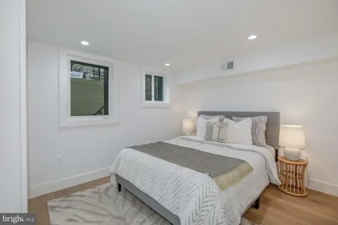 a kitchen with stainless steel appliances white cabinets and a potted plant