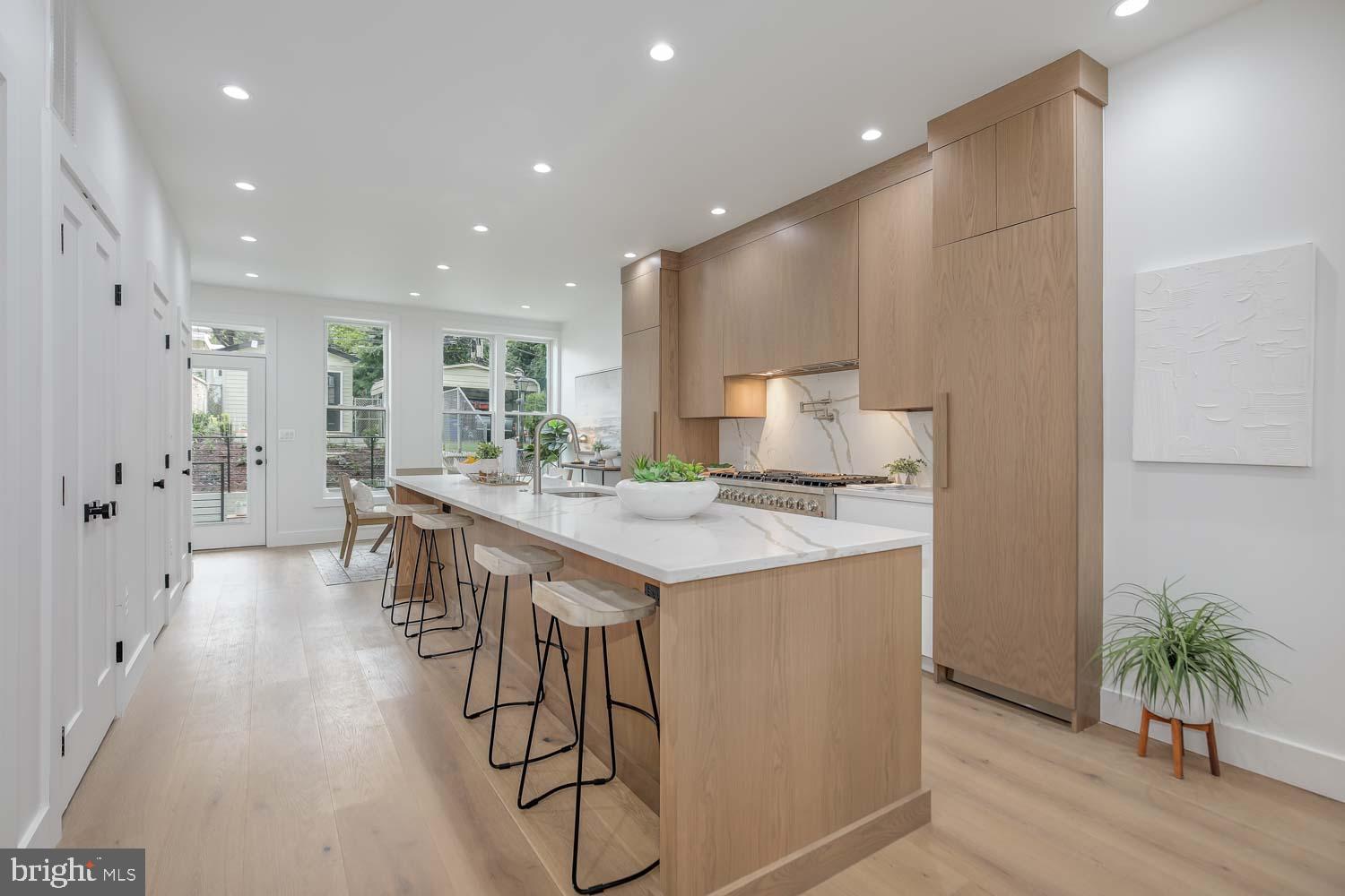 1438 Taylor Street Northwest Washington, DC 20011 - Photo 4 of 26 a kitchen with stainless steel appliances kitchen island granite countertop a refrigerator and a sink