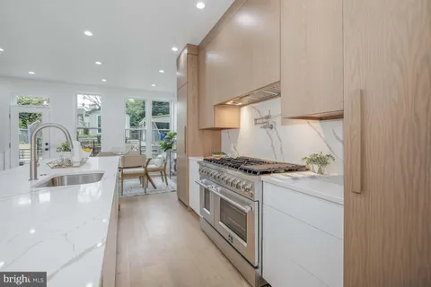 a kitchen with stainless steel appliances kitchen island granite countertop a refrigerator and a sink