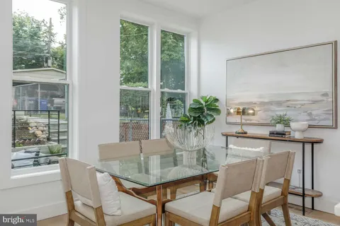 a kitchen with stove a sink and chairs