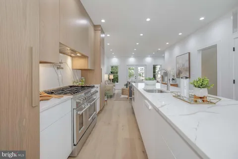a kitchen with a sink a counter top space and stainless steel appliances