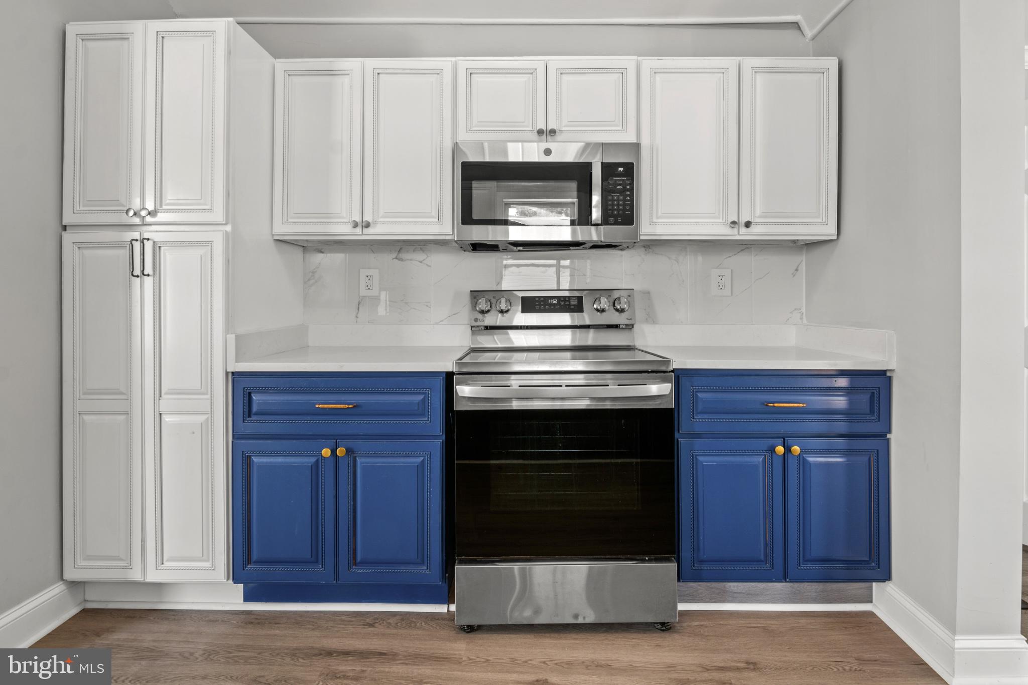 315 Riverside Drive Essex, MD 21221 - Photo 12 of 33 a kitchen with stainless steel appliances granite countertop a stove and a microwave
