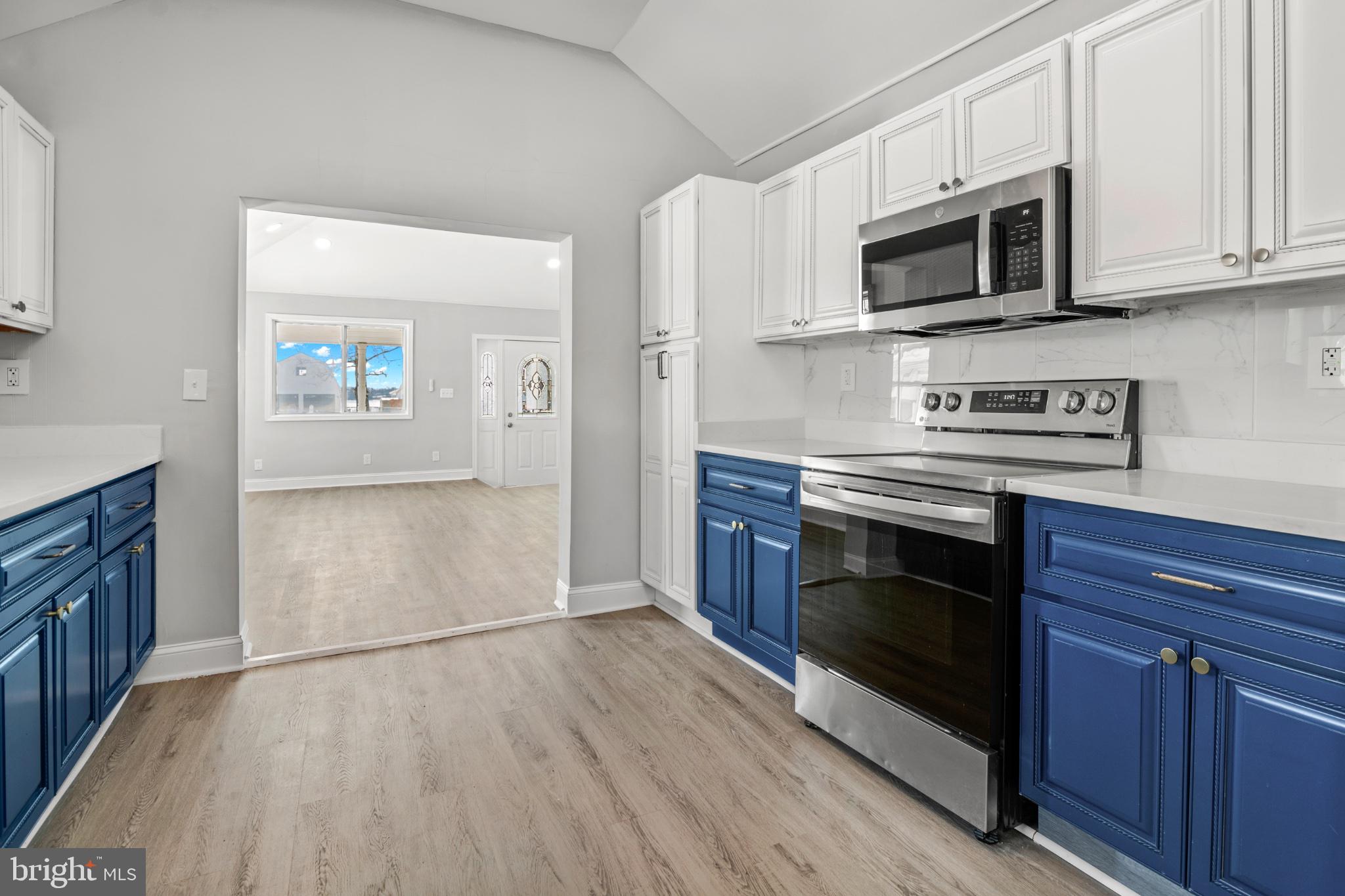 315 Riverside Drive Essex, MD 21221 - Photo 13 of 33 a kitchen with stainless steel appliances granite countertop a stove microwave and cabinets
