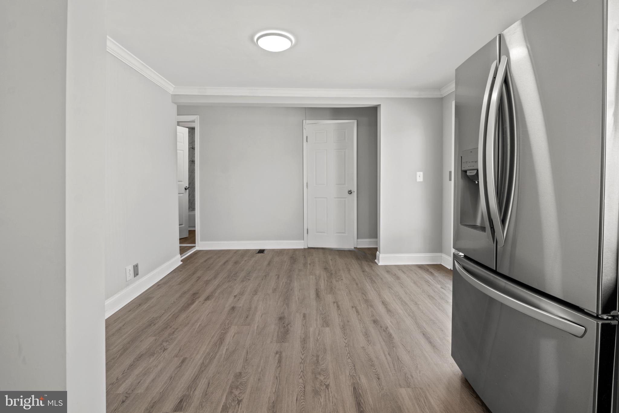 315 Riverside Drive Essex, MD 21221 - Photo 17 of 33 an empty room with wooden floor and entrance