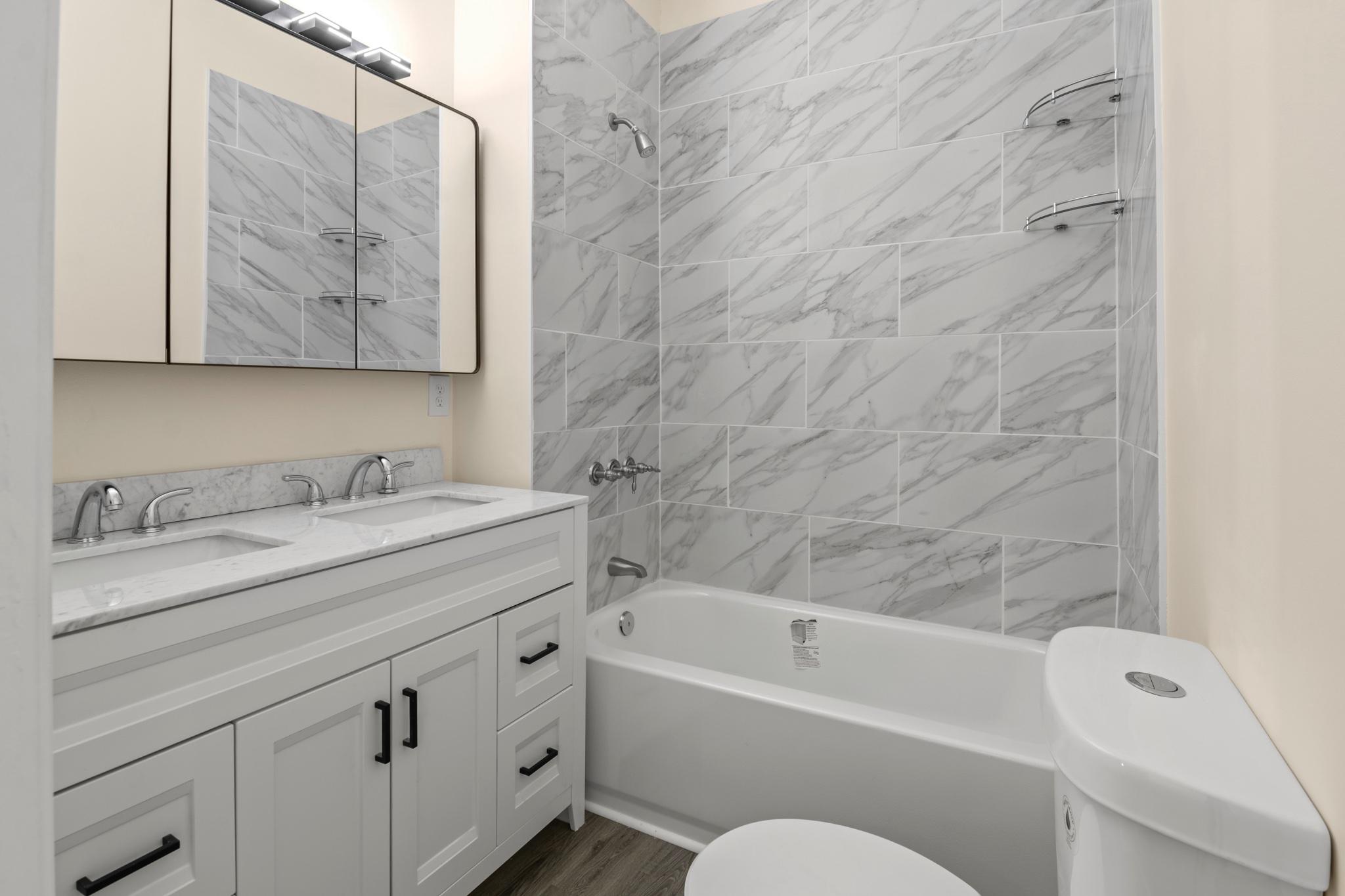 315 Riverside Drive Essex, MD 21221 - Photo 20 of 33 a bathroom with a granite countertop sink a toilet and bathtub