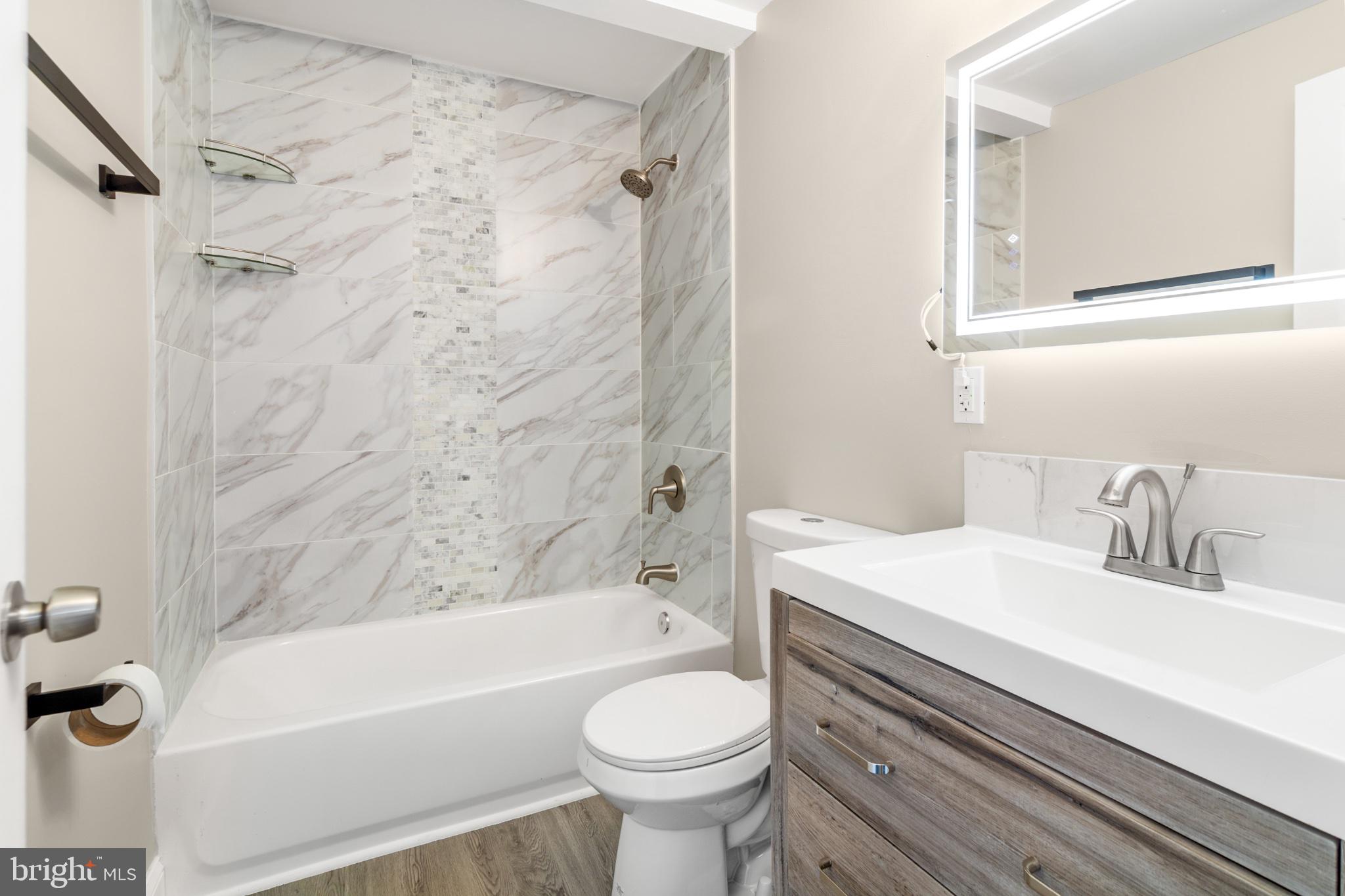315 Riverside Drive Essex, MD 21221 - Photo 23 of 33 a bathroom with a sink a toilet and a bathtub