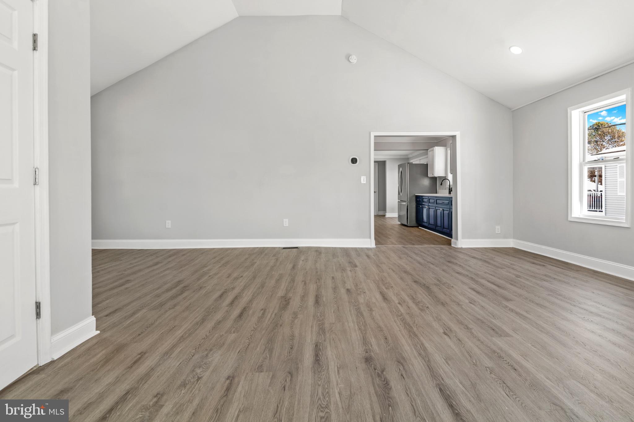 315 Riverside Drive Essex, MD 21221 - Photo 3 of 33 an empty room with wooden floor and windows