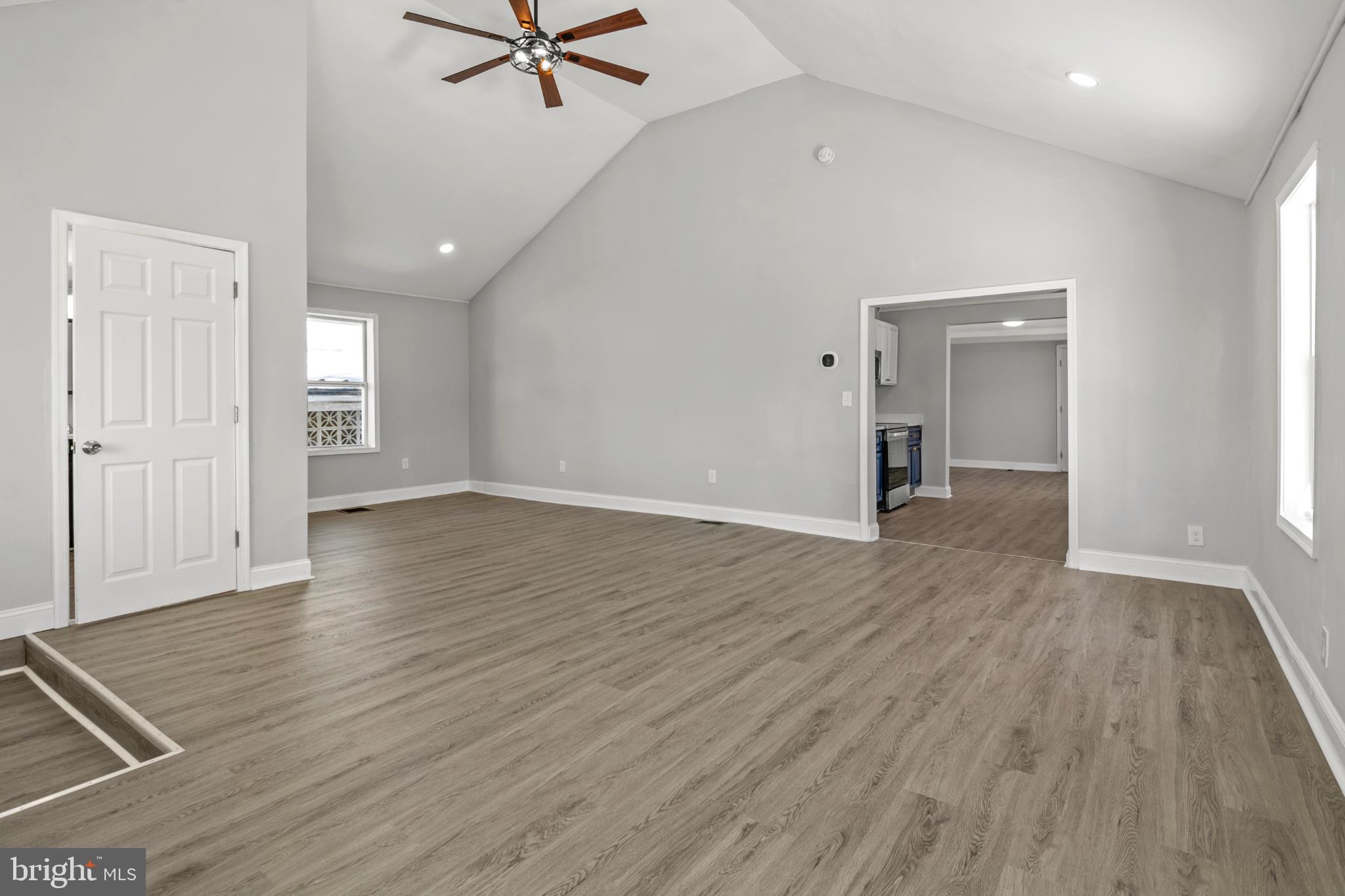 315 Riverside Drive Essex, MD 21221 - Photo 4 of 33 an empty room with wooden floor and windows