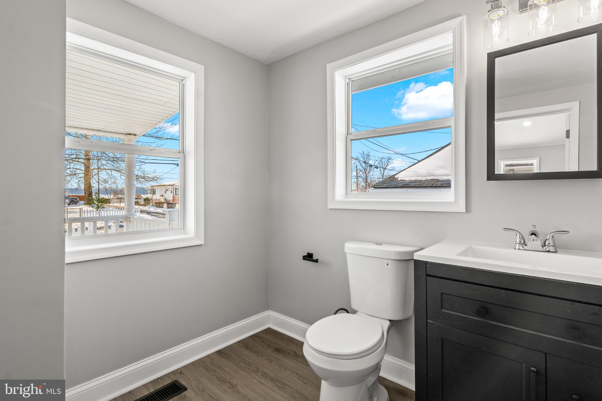 315 Riverside Drive Essex, MD 21221 - Photo 5 of 33 a bathroom with a toilet sink and mirror