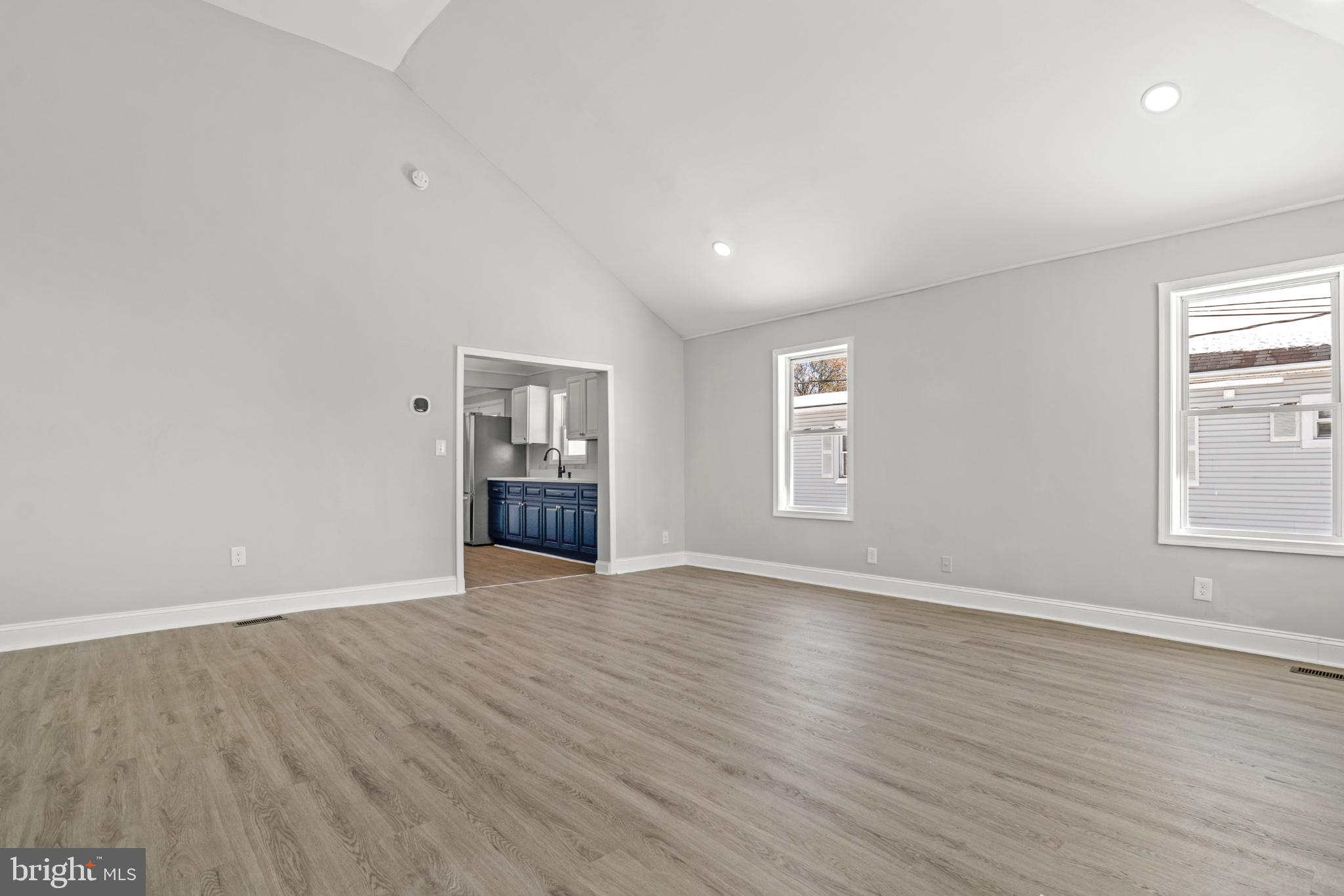 315 Riverside Drive Essex, MD 21221 - Photo 7 of 33 an empty room with wooden floor and windows