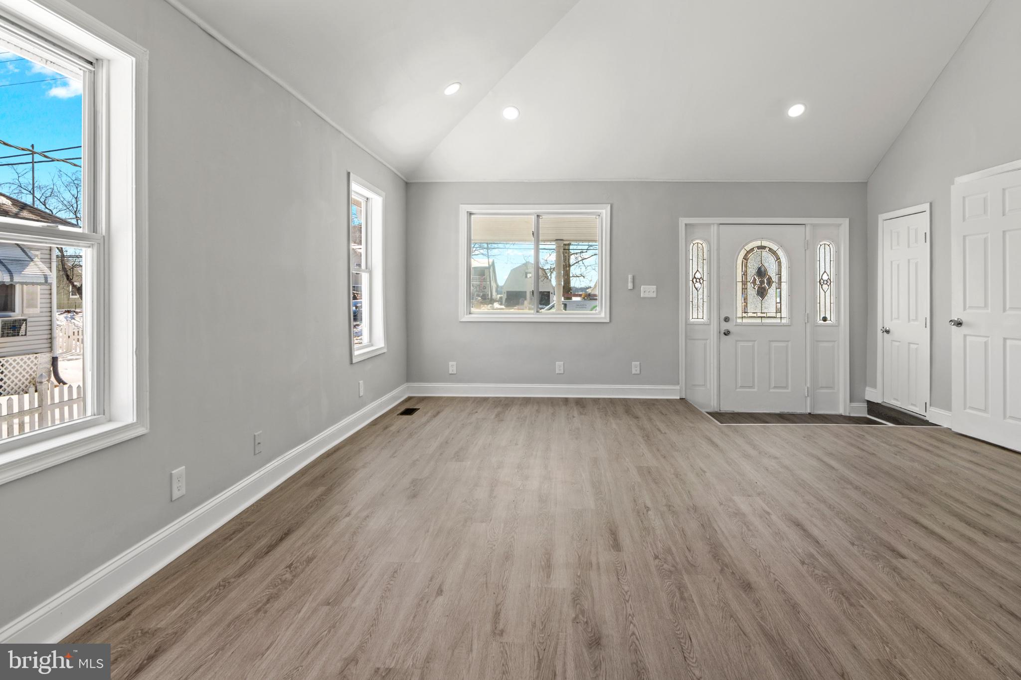 315 Riverside Drive Essex, MD 21221 - Photo 8 of 33 an empty room with wooden floor and windows